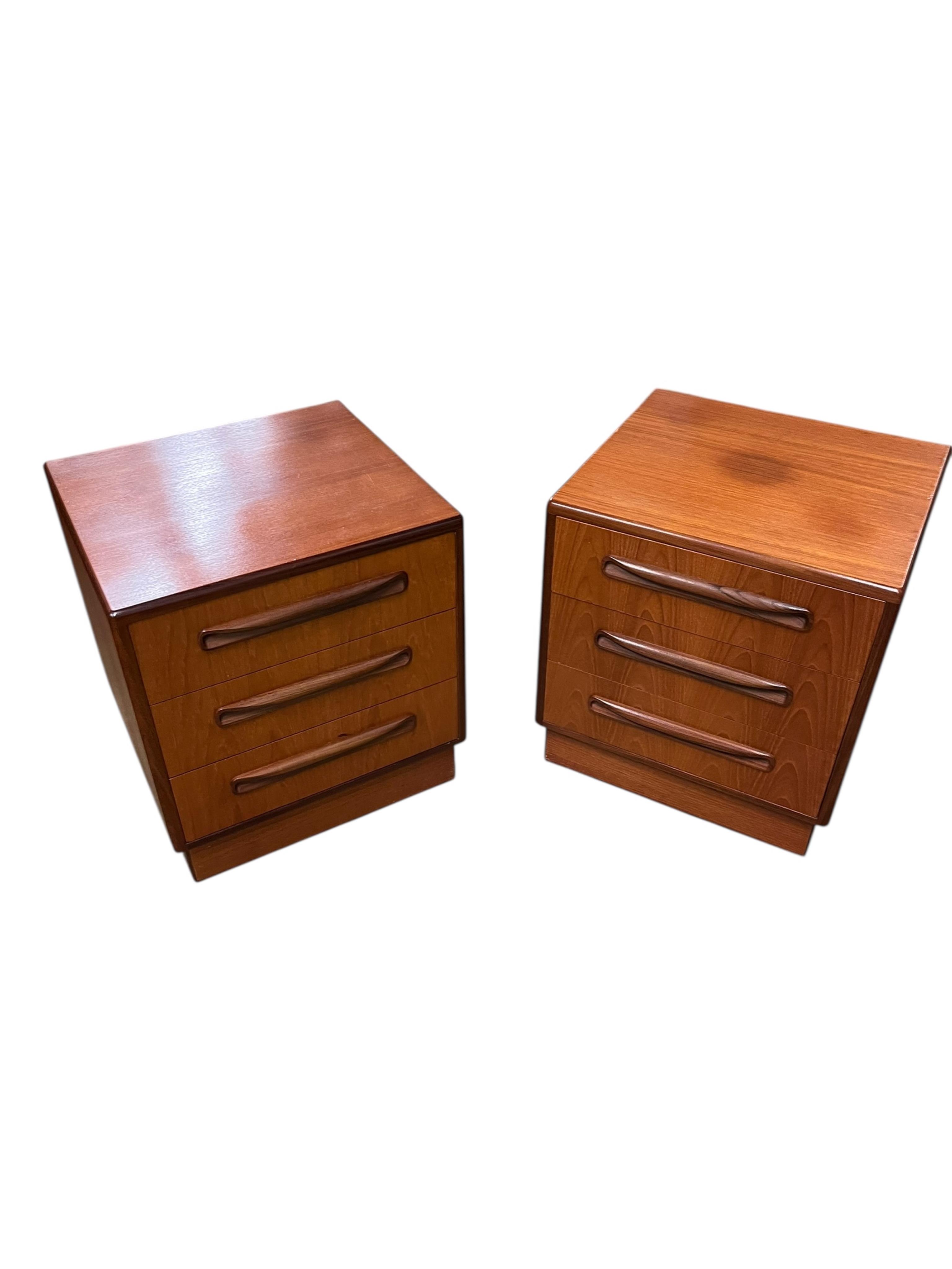 A mid century G Plan Fresco teak bedroom suite comprising a three door wardrobe, a two door wardrobe, two six drawer chests, dressing table, headboard and a pair of bedside chests